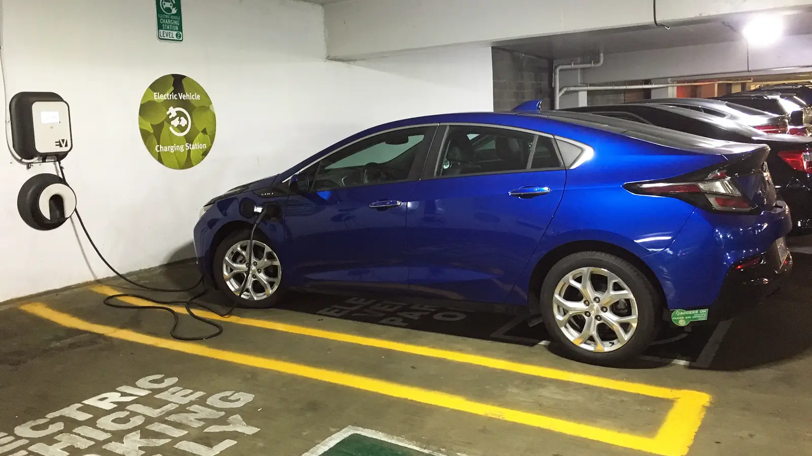 An electric car charging at a Level 2 station in a parking garage at Fashion Centre at Pentagon City. It is a private charger, not one of the county's.