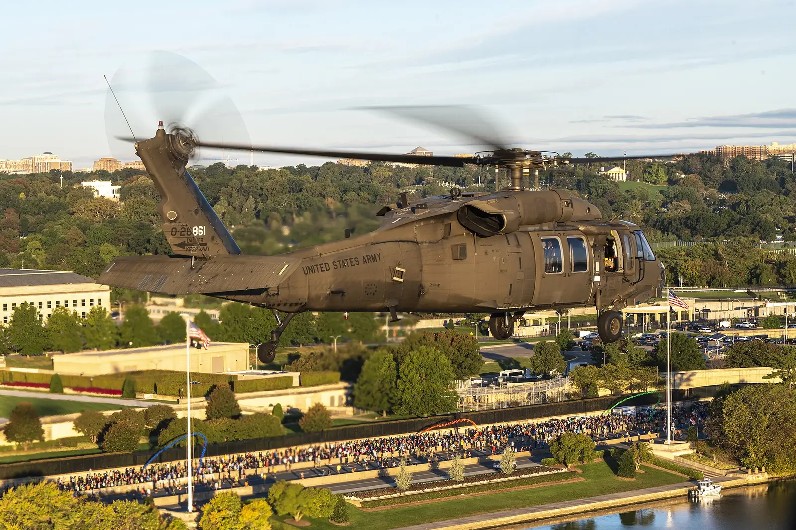Four UH-60 Black Hawk helicopters fly over the start of the Army Ten-Miler at the Pentagon in Arlington, Va., during the national anthem.
