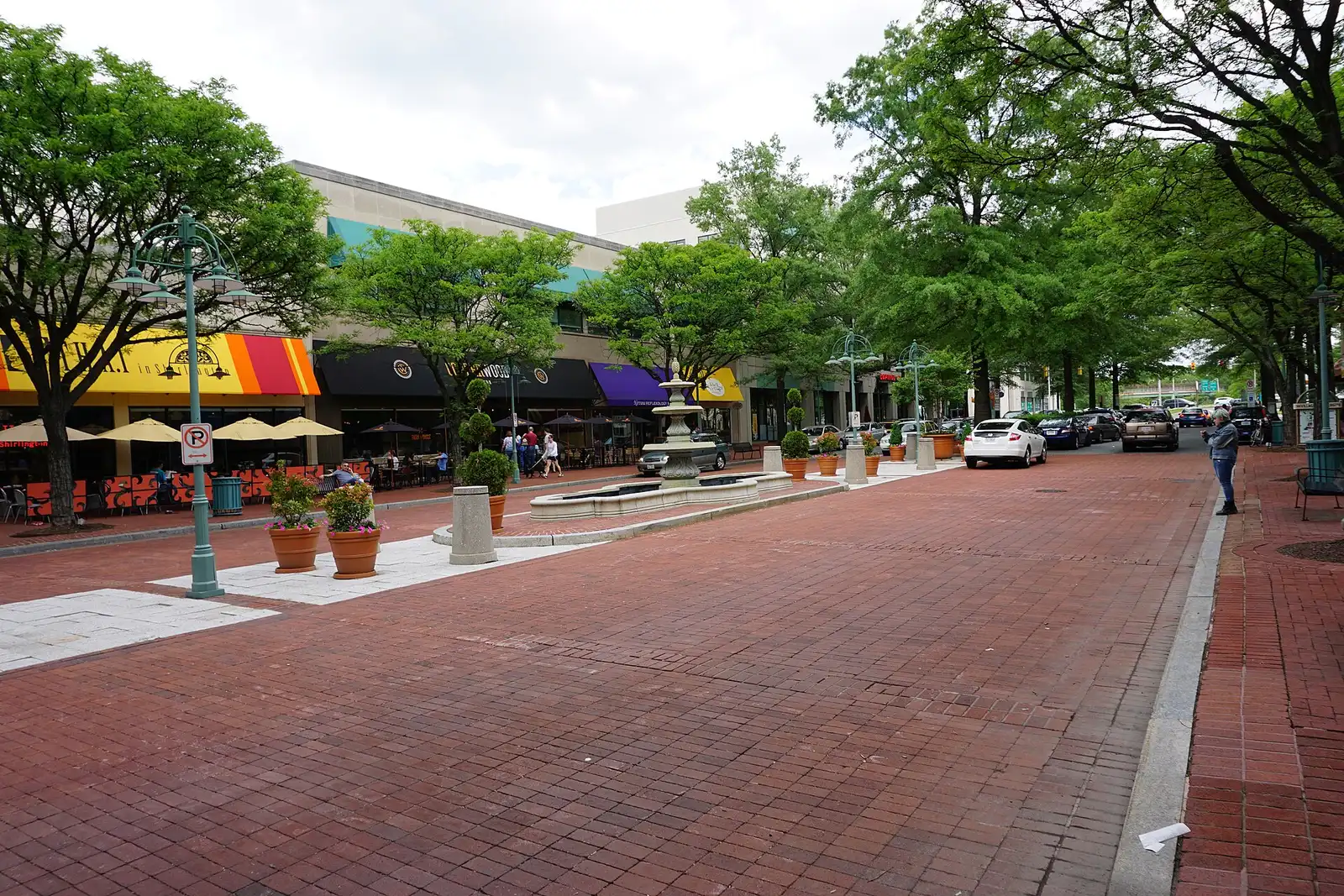 The fountain in the median of Campbell Avenue at the Village at Shirlington, lined with restaurants.