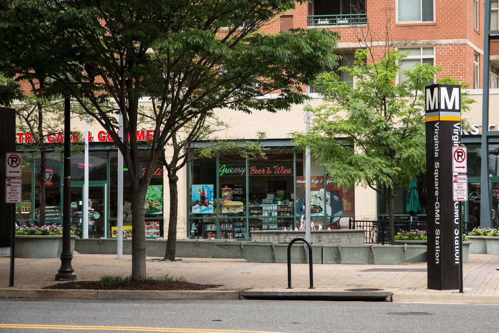 Shops and the station pylon at the Virginia Square-GMU Metrorail station entrance in Arlington.