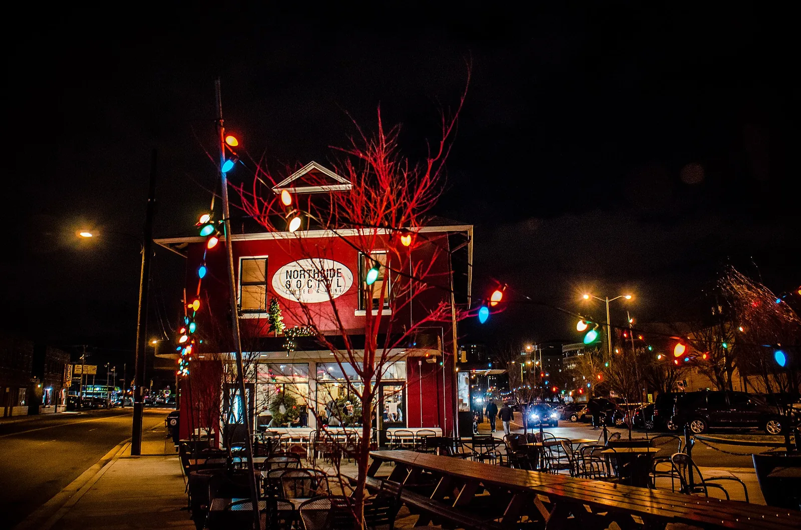 Outdoor tables at Northside Social on Wilson Boulevard in Clarendon, lit for the holidays at night.
